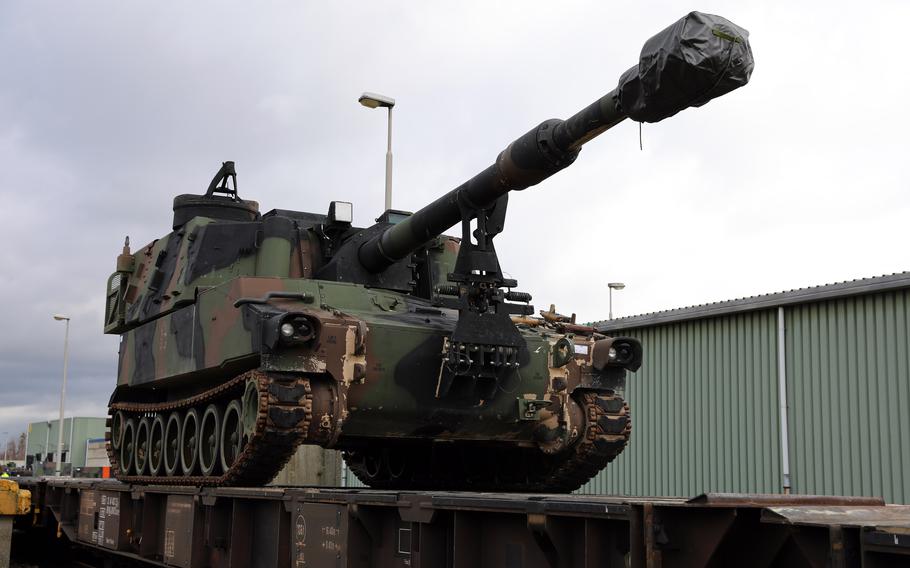 A M109A6 Paladin waits to be guided into position on a railcar in Eygelshoven, Netherlands, in 2019. Within three weeks, more than 700 pieces of equipment were moved to Poland. 