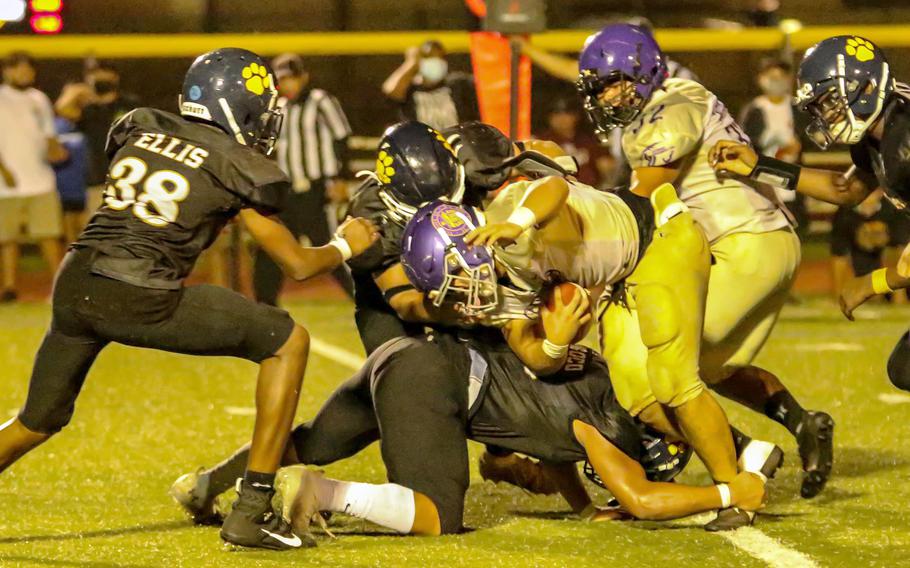 George Washington's Mykai Blas gets wrapped up by Guam High's defense.