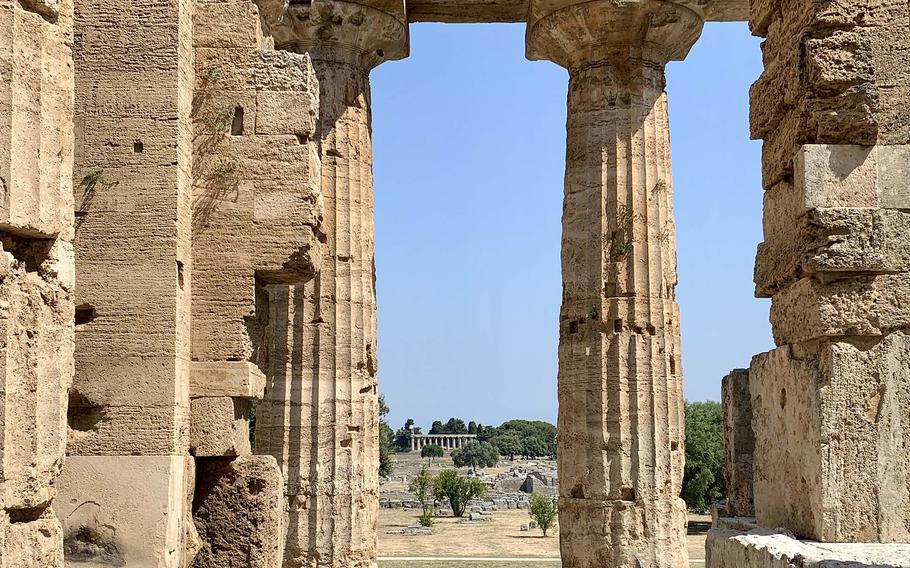 The Temple of Athena is visible from the Temple of Neptune at the ruins of Paestum in Italy. 