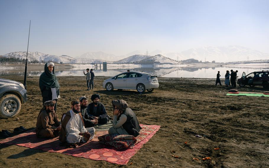 Taliban officials have tea at Qargha Reservoir in Kabul, where some have moved since the 2021 takeover.
