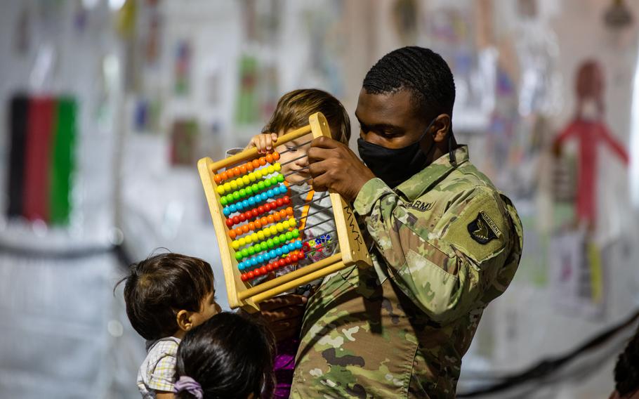 Army Pfc. Tavarez Burroughs, a culinary specialist, oversees Afghan children Oct. 20, 2021, in the living-support area at Fort Lee, Va., as part of Operation Allies Welcome. The Defense Department is providing transportation, temporary housing, medical screening, and general support for more than 53,000 Afghan evacuees at suitable facilities at eight military bases throughout the United States.