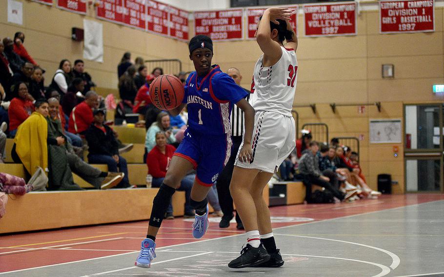 Ramstein's Javionne Jones dribbles around Raider Emma Arambula during a Dec. 14, 2023, game at Kaiserslautern High School in Kaiserslautern, Germany.