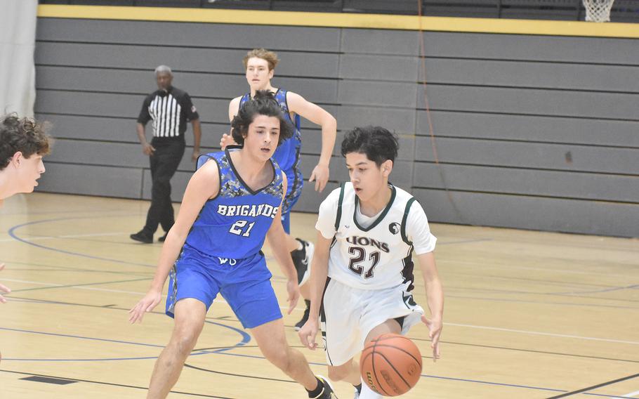 Brussels' Matej Marinkovic guards AFNORTH's Ricky Saldana during play Friday, Feb. 25, 2022, at the DODEA-Europe Division III basketball championships.