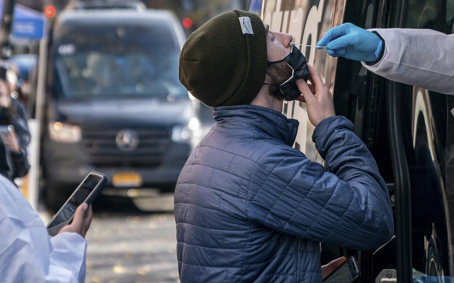 A person has a COVID-19 test administered at a walk-up testing site on Dec. 15, 2021, in New York City. The city’s public health system has been shutting down hundreds of testing sites as public attention to the virus fades, even as cases are surging nationwide in July 2022.