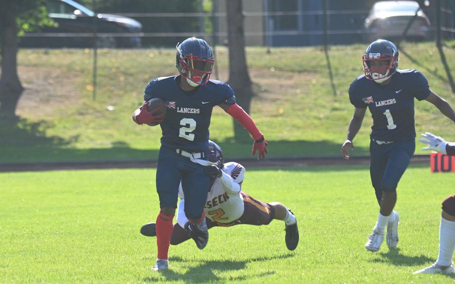 Lakenheath senior running back Brian Miles breaks through the tackles of Vilseck defenders during a football game on Friday, Sept. 15 in Vilseck, Germany. 