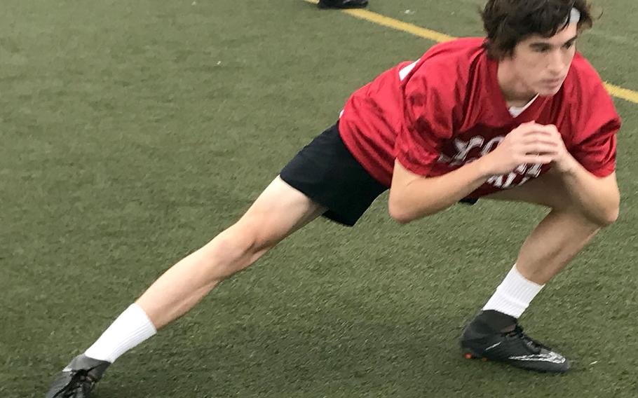 Nile C. Kinnick senior Ryo Nishiyama stretches out during warmups for Red Devils practice Friday.