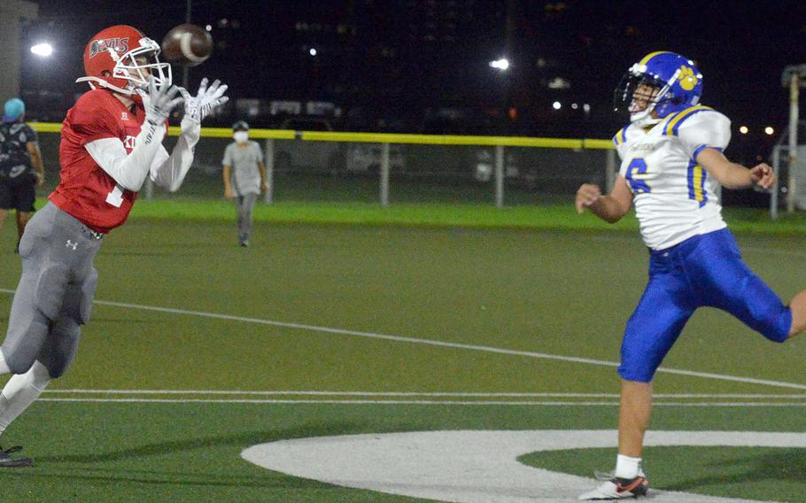 Nile C. Kinnick receiver Ryo Nishiyama hauls in a touchdown pass in front of Yokota defender Tre Perkins.