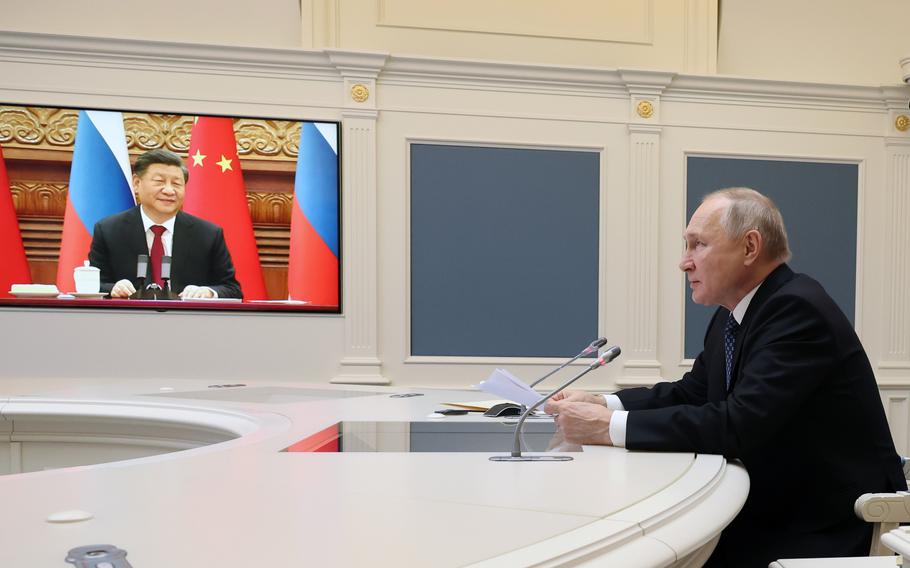 Russian President Vladimir Putin speaks during a meeting with Chinese President Xi Jinping, seen onscreen, via a video conference at the Kremlin in Moscow, Russia, Friday, Dec. 30, 2022.