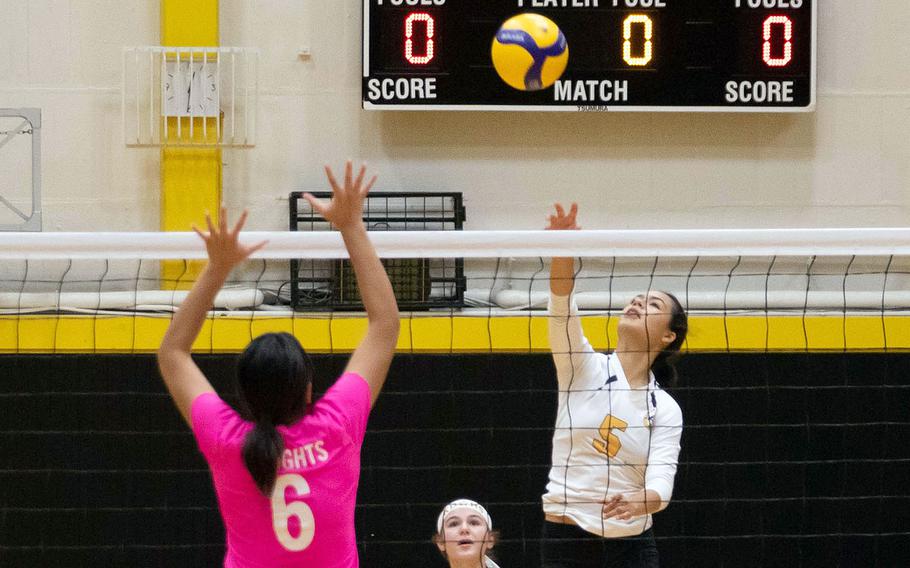 Kadena's Haide Alvarez spikes against Christian Academy Japan's Kee Thomas during the Panthers' straight-set win over the Knights during Friday's American School In Japan YUJO Tournament pool-play match.