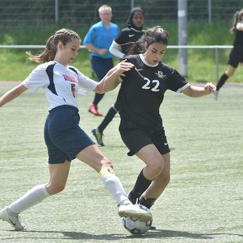 Aviano's Makinley Carroll and Bahrain's Mariam Kharat battle for the ball on Tuesday, May 17, 2022, at the DODEA-Europe girls Division II soccer championships at Landstuhl, Germany.