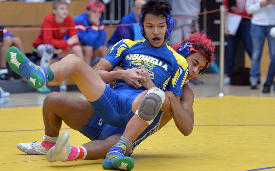 Ramstein’s Brian McKinley pulls down Sigonella’s Norman Nguyen in a 126-pound match at the 2020 DODEA-Europe wrestling championships in Wiesbaden that McKinley won.