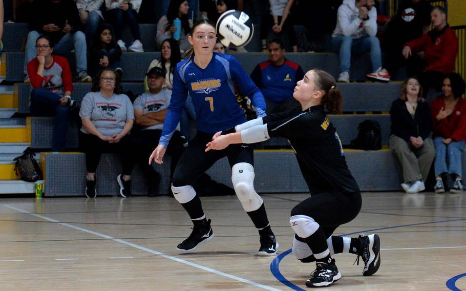 Wiesbaden’s Sailor Allred takes in a Ramstein serve as teammate Audrey Garrison watches, in the Division I championship game against Ramstein at the DODEA-Europe volleyball championships at Ramstein, Germany, Oct. 28, 2023. The Warriors prevailed in five sets 25-18, 12-25, 25-16, 22-25,15-13, to take the title.
