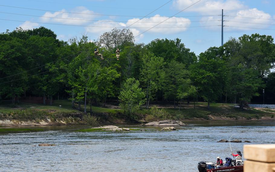 Soldiers in the Army’s Best Ranger Competition zip-line across the Chattahoochee River in downtown Columbus, Ga., on Saturday, April 15, 2023. 