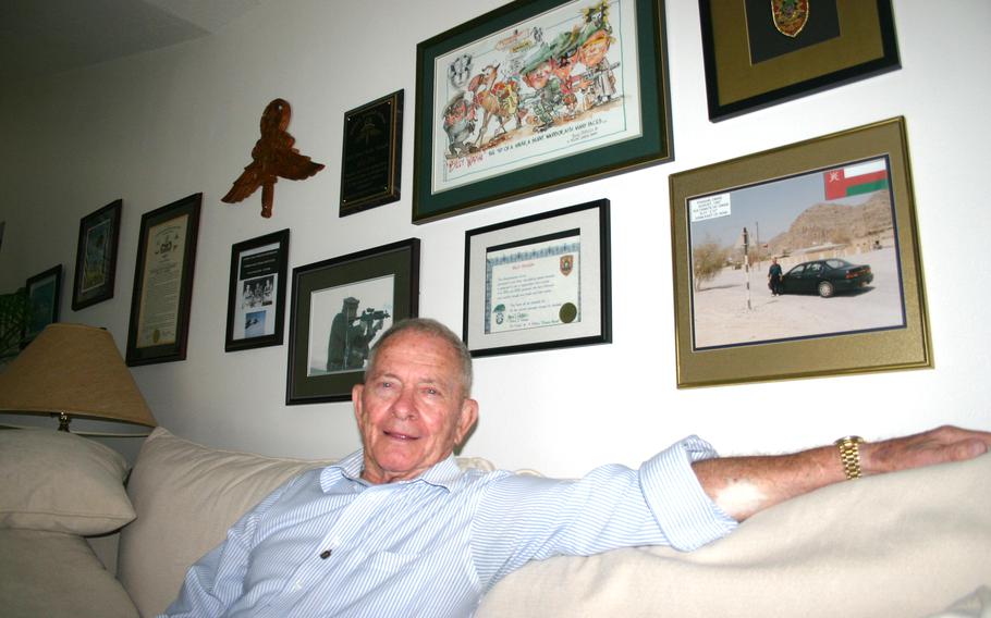 William “Billy” Waugh relaxing at home. Behind him are photos and other memorabilla from his years of military and CIA service. Waugh, a Green Beret and CIA legend who served in wars in Korea, Vietnam and Afghanistan, died Tuesday at 93 years old, U.S. military officials said. 