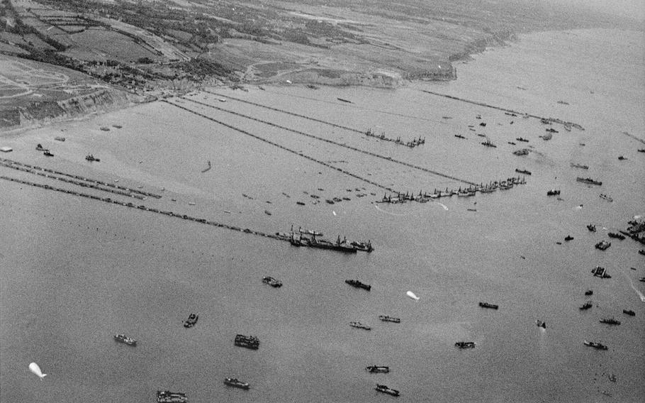 An aerial photograph of the Mulberry Harbor off Arromanches, France. Artificial harbors were constructed along the beach shortly after D-Day so that armored vehicles and heavy guns could land.