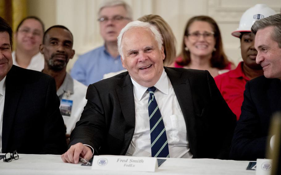 Fred Smith smiles during a signing ceremony at the White House.