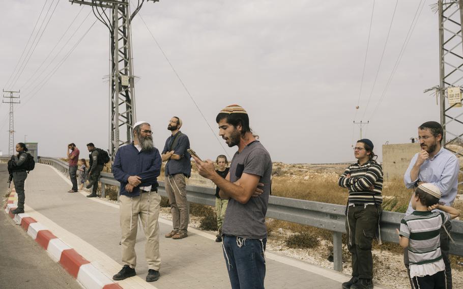 Settlers from Kochav Hashachar on the road to Taybeh.