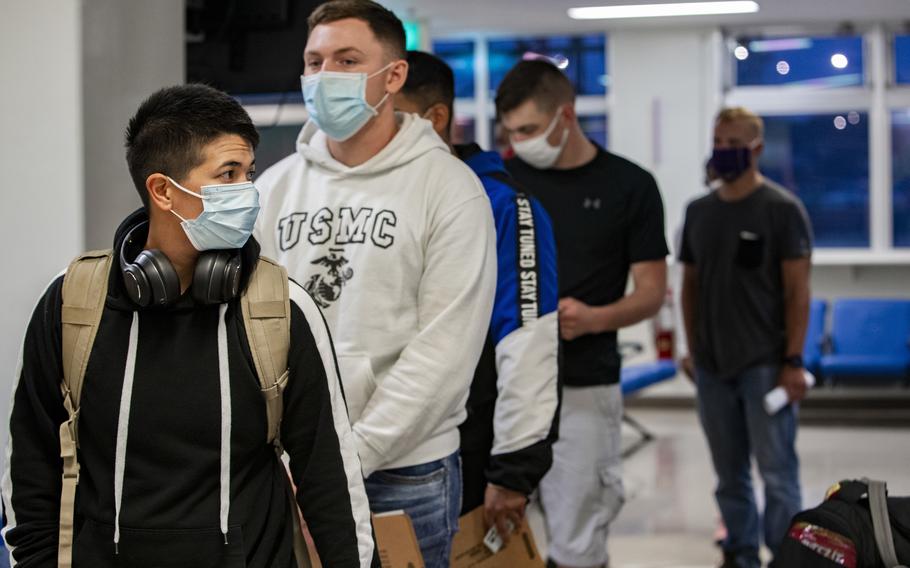 Marines wait inside the passenger terminal at Kadena Air Base, Okinawa, on June 6, 2020. 