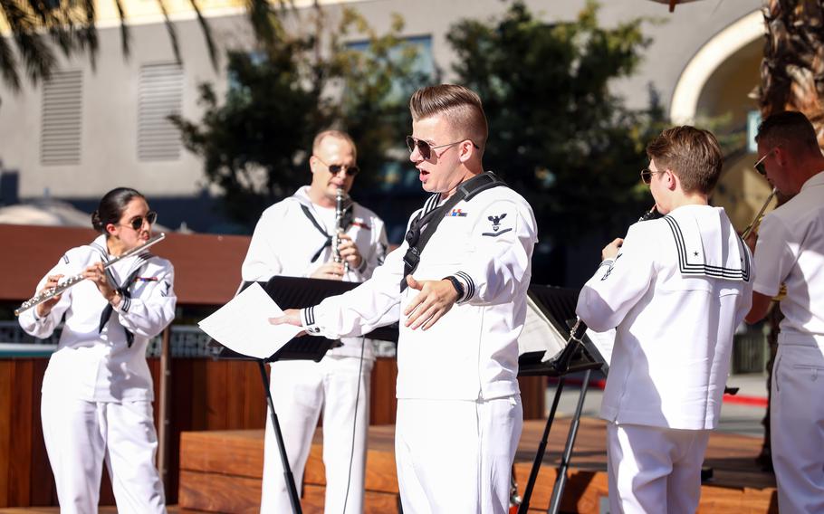 Alexander Charles, center, sings for the US Navy Band Southwest Woodwind Quintet at Santana Row’s Valencia Plaza in San Jose, Calif., on Aug. 15, 2022. The quintet played two 45-minute sets to help kick off Navy Week in San Jose. 