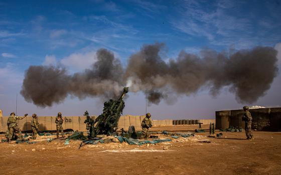 Smoke rises after soldiers fire a M777 Howitzer.