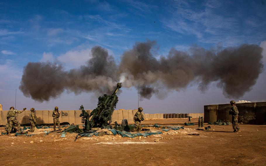 Smoke rises after soldiers fire a M777 Howitzer.