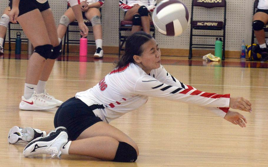 E.J. King's Sandara Mundy digs the ball during the Cobras' three-set volleyball victory Saturday over Matthew C. Perry.
