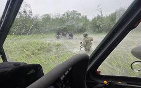 Alaska Army National Guard Chief Warrant Officer 3 Nick Lime, an aviator assigned to 207th Aviation Battalion, assists six distressed people stranded on the Kuskokwim River during a rescue mission June 30, 2025. The Alaska Rescue Coordination Center opened the mission in response to an Alaska State Troopers request for assistance when the family’s boat became stuck on a sandbar in the river. (Alaska National Guard courtesy photo by Chief Warrant Officer 3 Bryan Kruse)