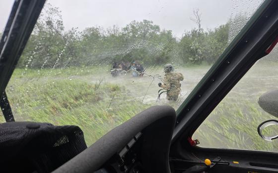 Alaska Army National Guard Chief Warrant Officer 3 Nick Lime, an aviator assigned to 207th Aviation Battalion, assists six distressed people stranded on the Kuskokwim River during a rescue mission June 30, 2025. The Alaska Rescue Coordination Center opened the mission in response to an Alaska State Troopers request for assistance when the family’s boat became stuck on a sandbar in the river. (Alaska National Guard courtesy photo by Chief Warrant Officer 3 Bryan Kruse)