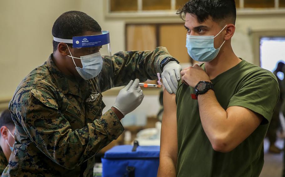Military medical personnel at Camp Lejeune, N.C., administer coronavirus vaccines in January. 