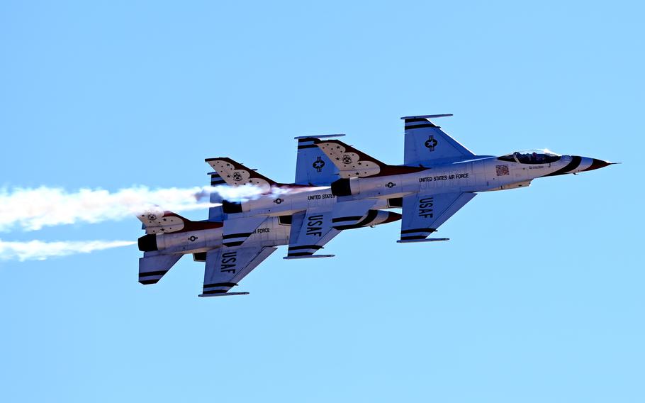 Three aircraft fly in formation in the sky