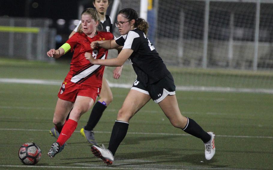 Nile C. Kinnick’s Bree Withers and Zama’s Daniella Reyes chase the ball during Friday’s DODEA-Japan girls soccer match. The Red Devils won 8-0.