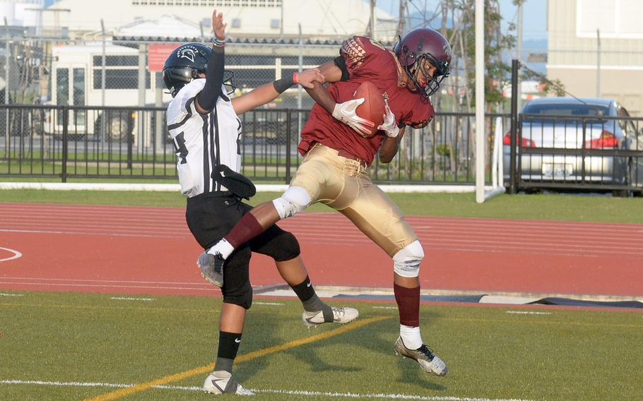 Matthew C. Perry receiver Shion Fleming outleaps Zama defender Kai Kuroki for a 29-yard touchdown catch.