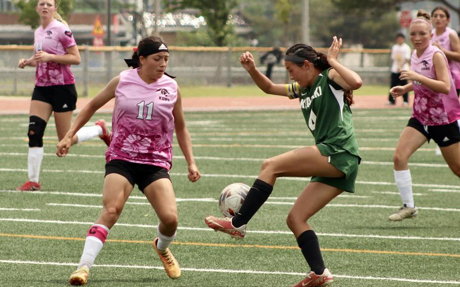 Kubasaki's Sakura Lopez plays the ball in front of Kadena's Emmah Strong.