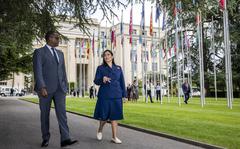 Rwandan Foreign Minister Vincent Biruta, left, and Britain's Home Secretary Priti Patel, right, walk in front of the European headquarters of the United Nations an interview with the Associated Press, in Geneva, Switzerland, Thursday, May 19, 2022. (Martial Trezzini/Keystone via AP)