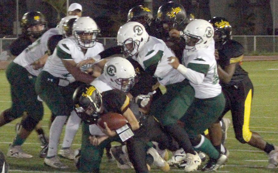 Kadena quarterback Anthony Skalamera dives into the end zone for a touchdown, on a play in which he fractured his wrist.