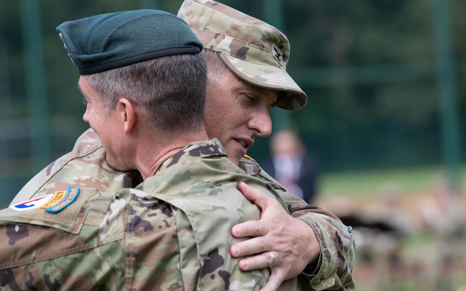 Col. Jeffery Higgins, left, embraces Col. Reid Furman after assuming command of U.S. Army Garrison Rheinland-Pfalz from him on July 11, 2024.