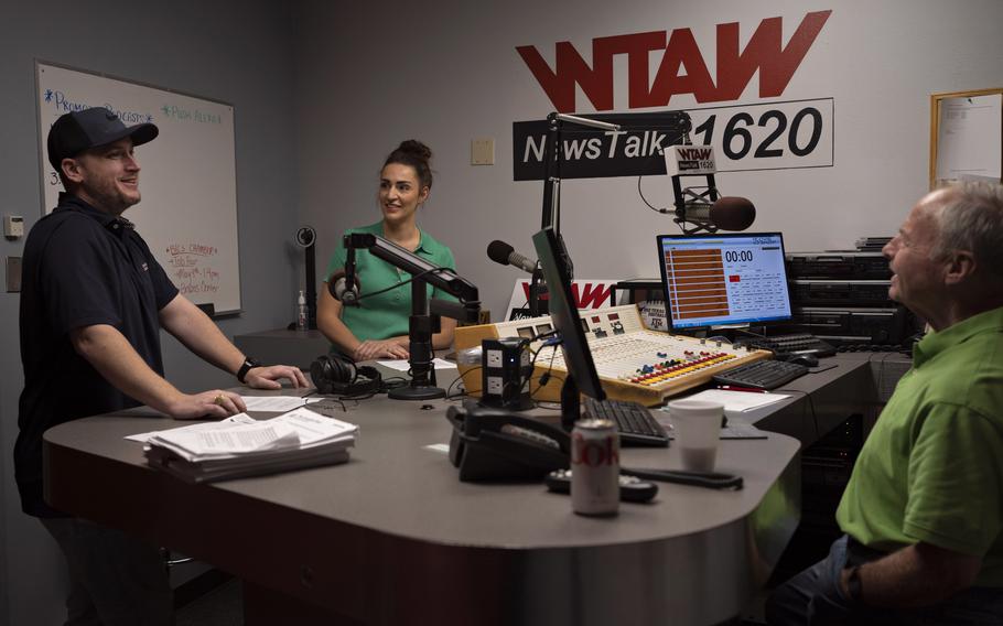Sportscaster Sean Burnett, reporter Chelsea Reber and host Scott DeLucia gather to discuss their notes before WTAW's morning show "The Infomaniacs" airs. 