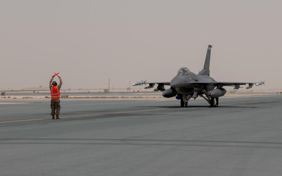 An F-16 assigned to the 148th Fighter Wing is directed on a taxiway on Al Udeid Air Base, May 25, 2022. The fighter jet's refueling marked the second time a hot pit refueling has been performed by the 379th Air Expeditionary Wing. 