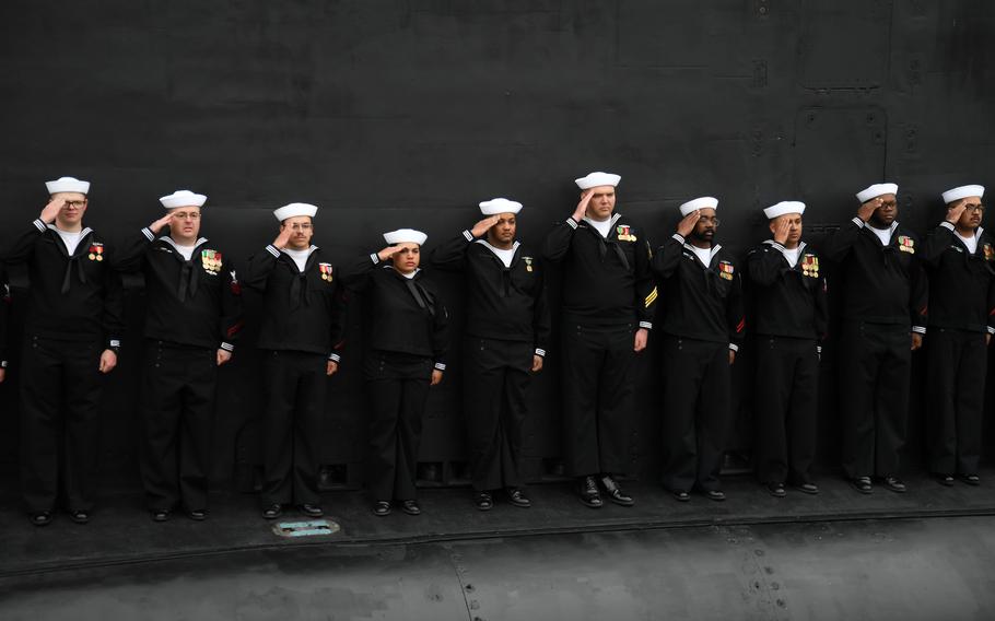 Sailors salute in formation
