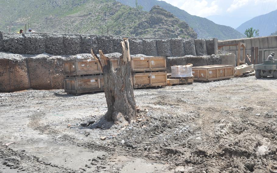 A burned tree stump remains at the site of a rocket attack at Combat Outpost Monti in Kunar River Valley on July 8, 2010, that burned two beehuts, killing PFC Anthony Simmons. 