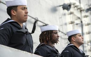 Sailors man the rails on the flight deck of the aircraft carrier USS Nimitz in Puget Sound, Washington, March 21, 2025. 