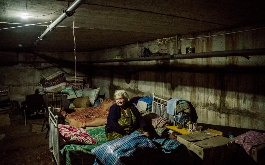 Marfa Ivanovna sits on her bed in a bomb shelter in the village of Kutuzivka on May 22. She sought refuge there in March.