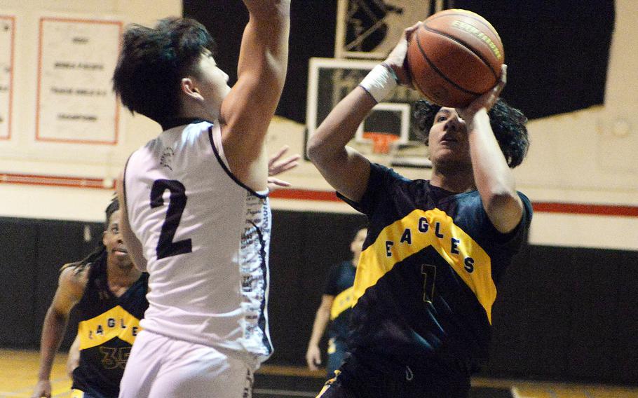 Robert D. Edgren's Micah Magat shoots against Zama's Keahnu Araki during Friday's DODEA-Japan boys basketball game. The Trojans won 61-37.