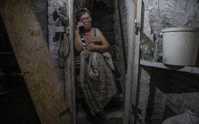 Kateryna Semenova shelters underground during a nearby Russian strike on Nikopol on Aug. 19. MUST CREDIT: Photo for The Washington Post by Heidi Levine