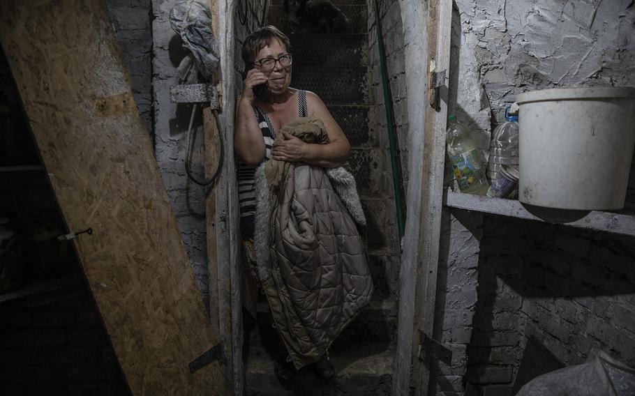 Kateryna Semenova shelters underground during a nearby Russian strike on Nikopol on Aug. 19, 2022.