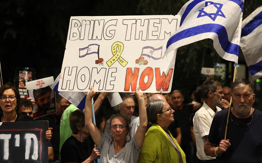 Relatives and supporters raise placards bearing messages and portraits of Israeli hostages held in Gaza since the Oct. 7 attacks by Hamas during a rally calling for their release, outside the PM’s office in Jerusalem on Wednesday, May 22, 2024.