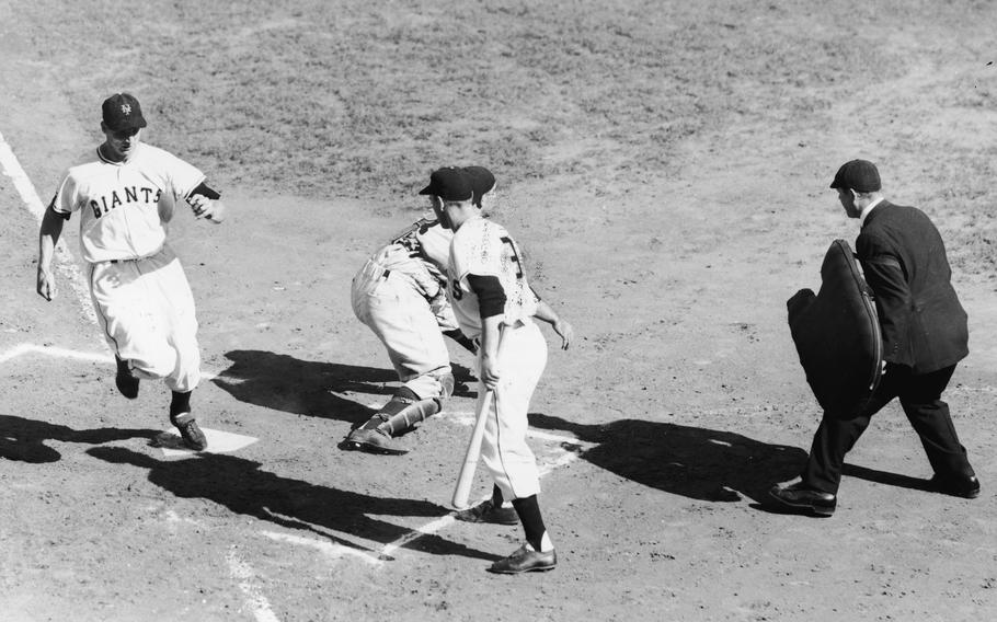 Bobbby Thomson (left) of the New York Giants scores a run in the second inning of game three of the World Series in New York, Oct. 6, 1951. The most famous home run in baseball history is arguably the walk-off by Thomson in the ninth inning of the final game of a 1951 National League playoff series with the Brooklyn Dodgers to clinch the pennant. It turns out the Giants were cheating by stealing the catcher’s signs and relaying them to batters from the scoreboard. Thomson denies seeing this specific signal, but those involved admit they had been telegraphing signals throughout the Giants’ pennant run.