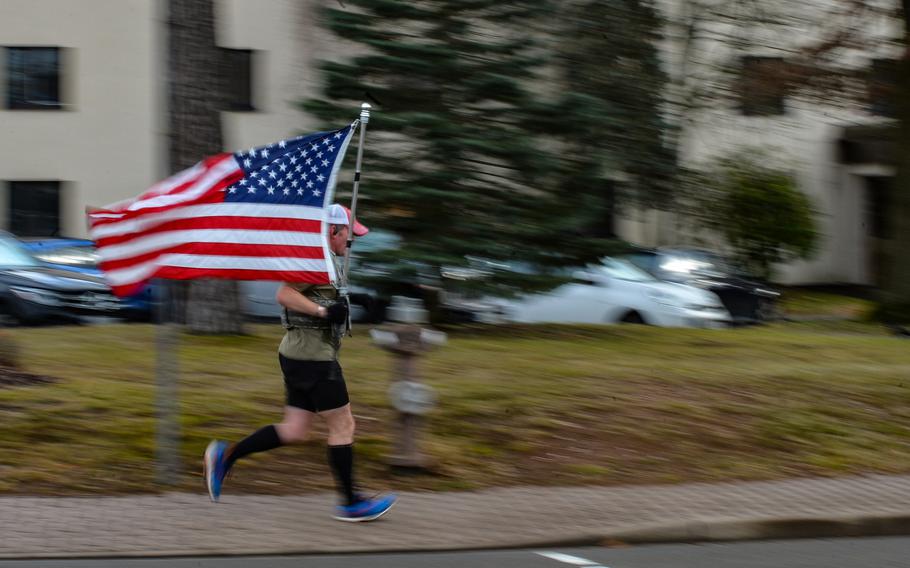 Air Force Master Sgt. Trevor Derr, the flight chief for the 721st Aircraft Maintenance Squadron at Ramstein Air Base, Germany, runs on base Dec. 7, 2021. Derr always carries a flag during his frequent runs to honor his friend and fellow airman, Tech. Sgt. Daniel Swaney, who died by suicide in 2015 while suffering from post-traumatic stress disorder. Derr also runs to raise awareness of PTSD and to honor all veterans.