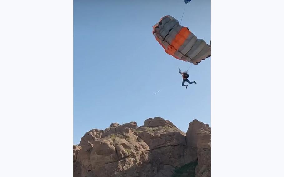 A video screen grab shows a parachute deploying after a 22 Jumps participant leapt off a cliff in Idaho.