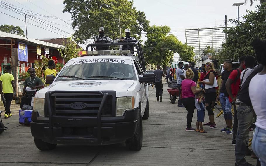 Members of the Mexican National Guard patrol the street outside one of the asylum offices in Tapachula, Mexico. 